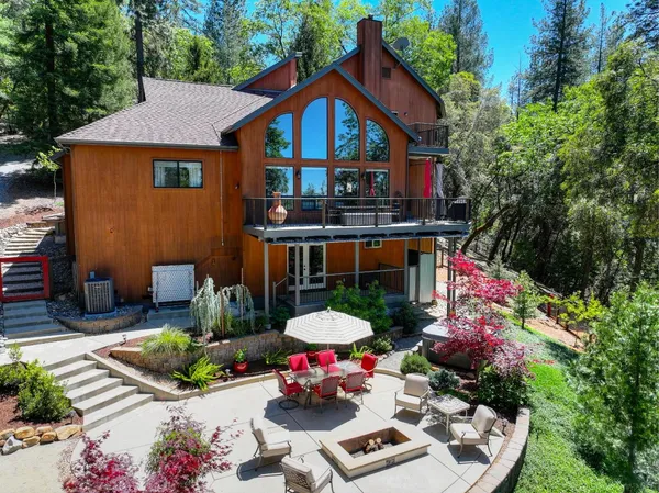 a front view of a house with yard and outdoor seating