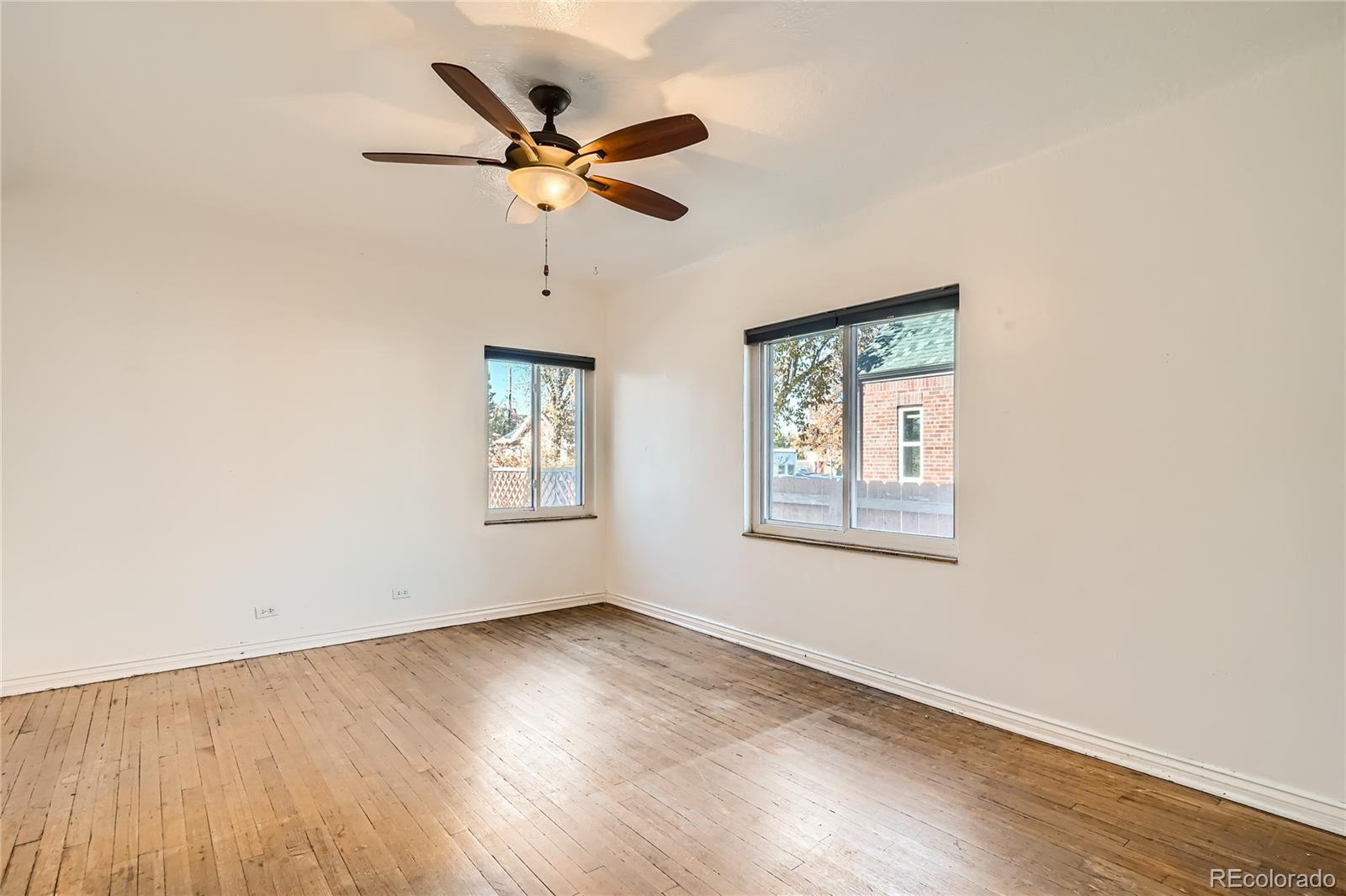 1460 Tennyson Street Denver, CO 80204 - Photo 16 of 44 a view of a room with wooden floor fan and windows