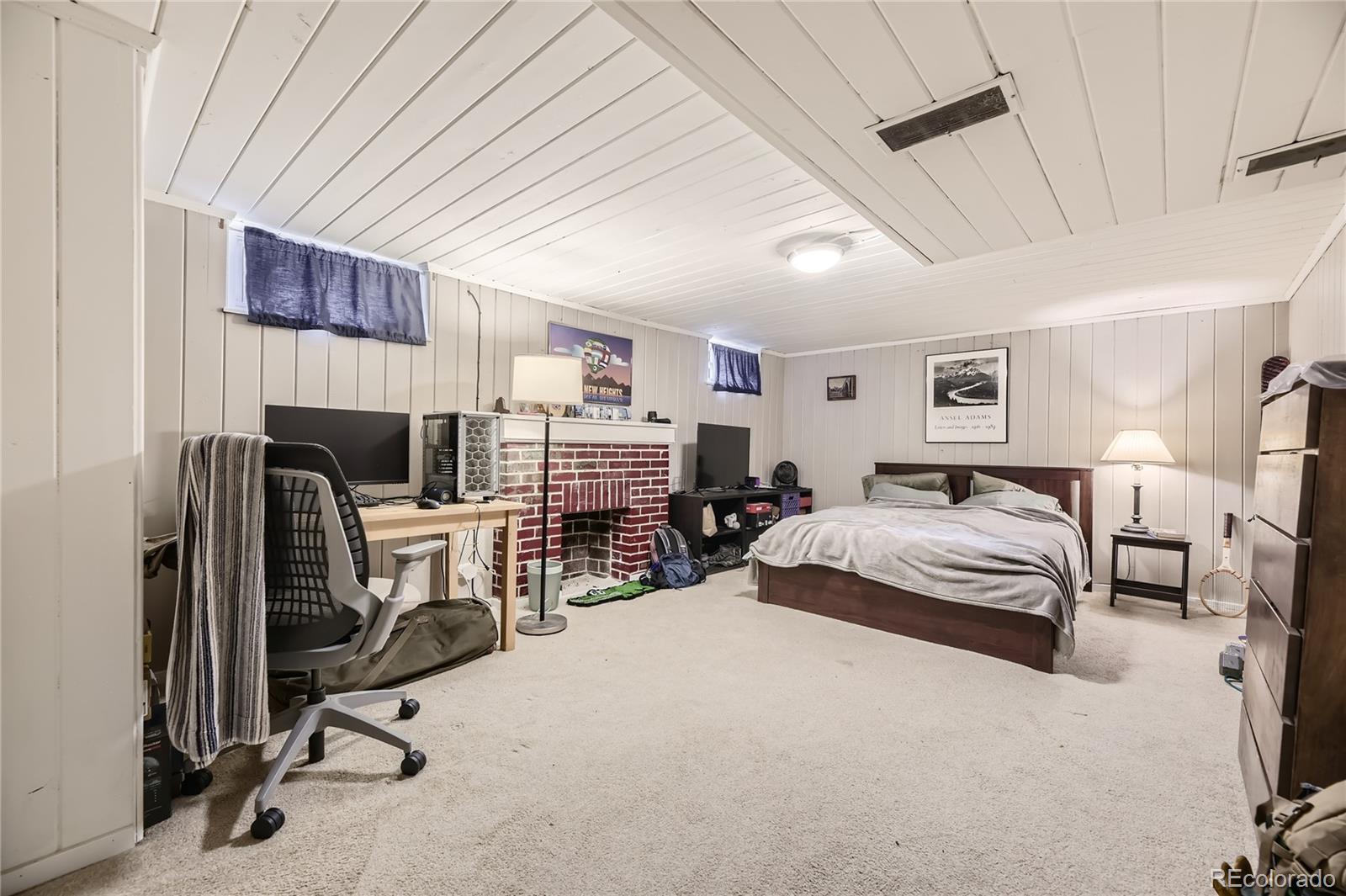 1460 Tennyson Street Denver, CO 80204 - Photo 21 of 44 a bedroom with furniture and a fireplace