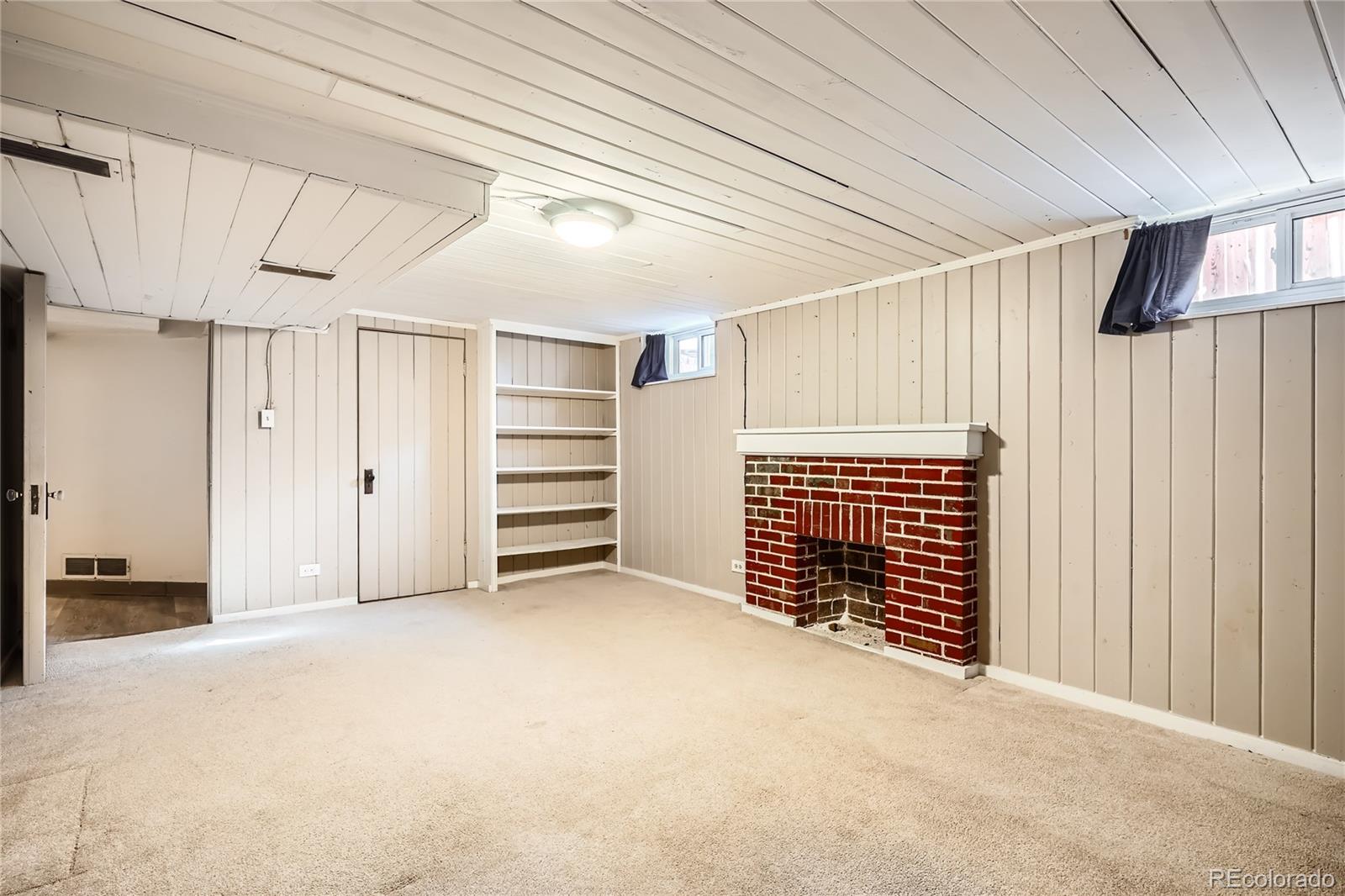 1460 Tennyson Street Denver, CO 80204 - Photo 22 of 44 a view of an empty room with a fireplace
