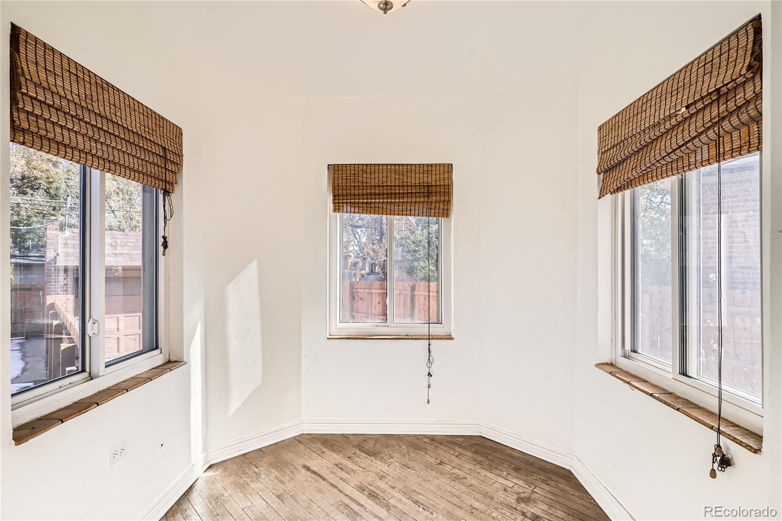 1460 Tennyson Street Denver, CO 80204 - Photo 9 of 44 a view of a bedroom with wooden floor and a window