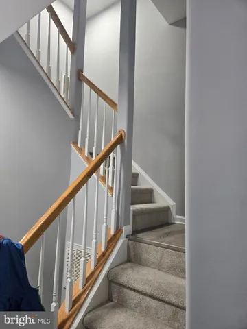 a view of staircase with lots of frames on wall