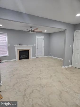 a view of empty room with a fireplace