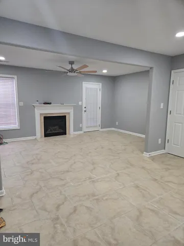 a view of empty room with a fireplace