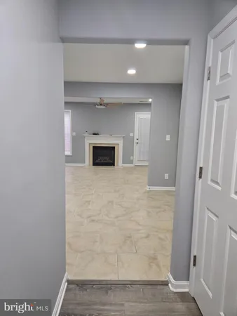 a view of empty room with a fireplace