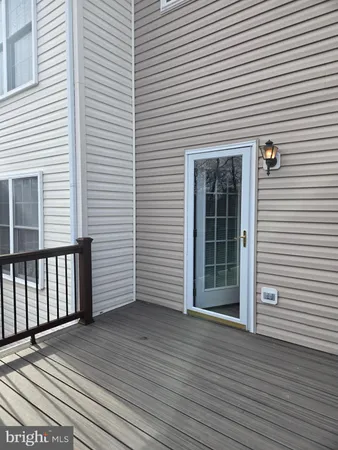 a view of a house with wooden deck