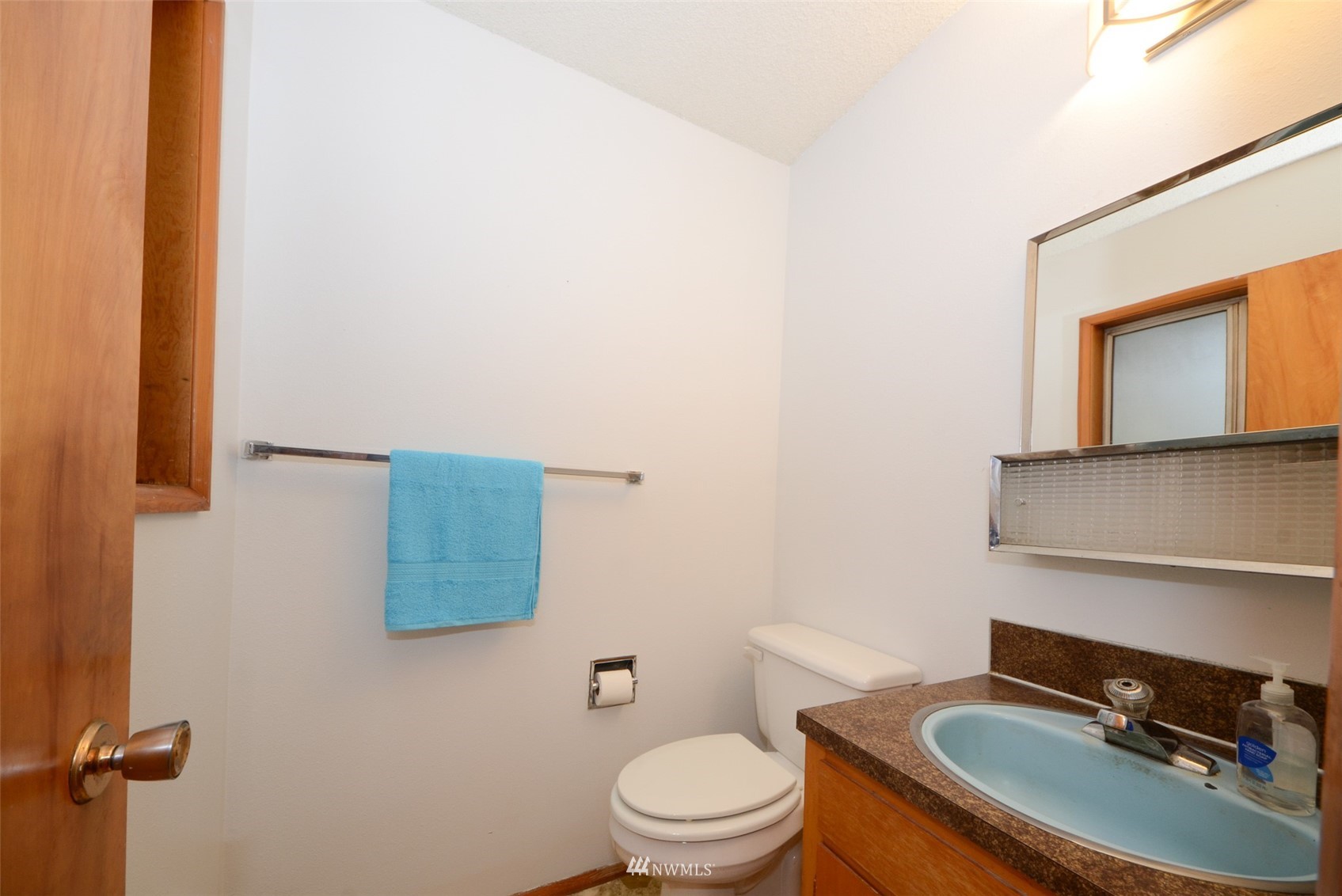 18524 Guava Street Southwest Rochester, WA 98579 - Photo 13 of 28 a bathroom with a toilet a sink and mirror