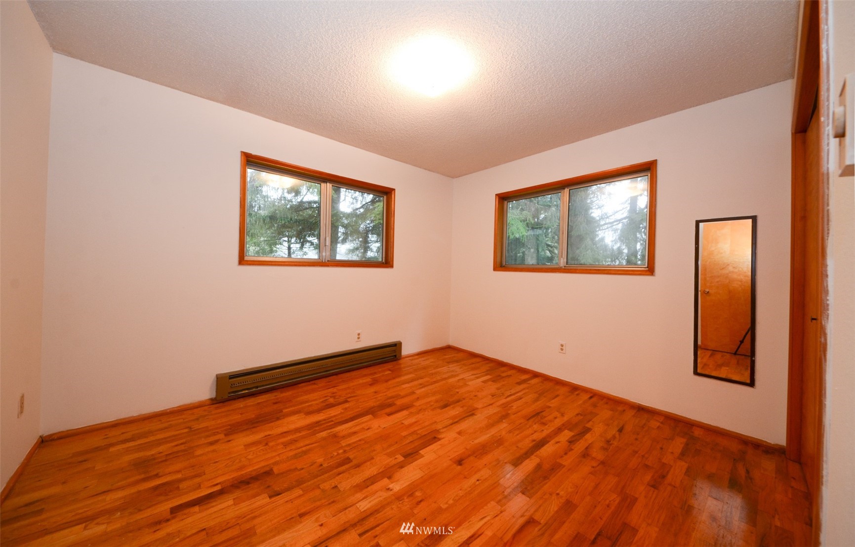 18524 Guava Street Southwest Rochester, WA 98579 - Photo 15 of 28 a view of empty room with wooden floor