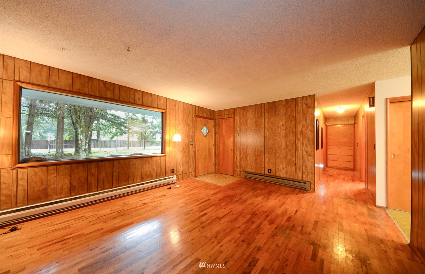 18524 Guava Street Southwest Rochester, WA 98579 - Photo 8 of 28 a view of an empty room with wooden floor and a window