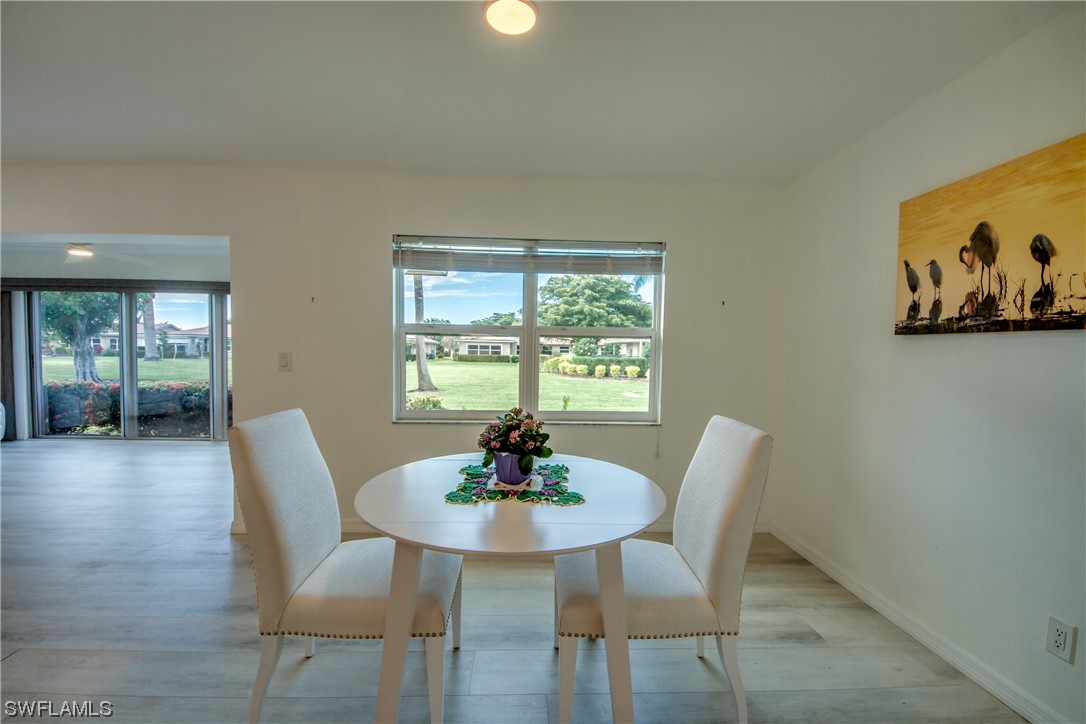 5585 Buring Court Fort Myers, FL 33919 - Photo 11 of 34 a dining room with furniture and wooden floor