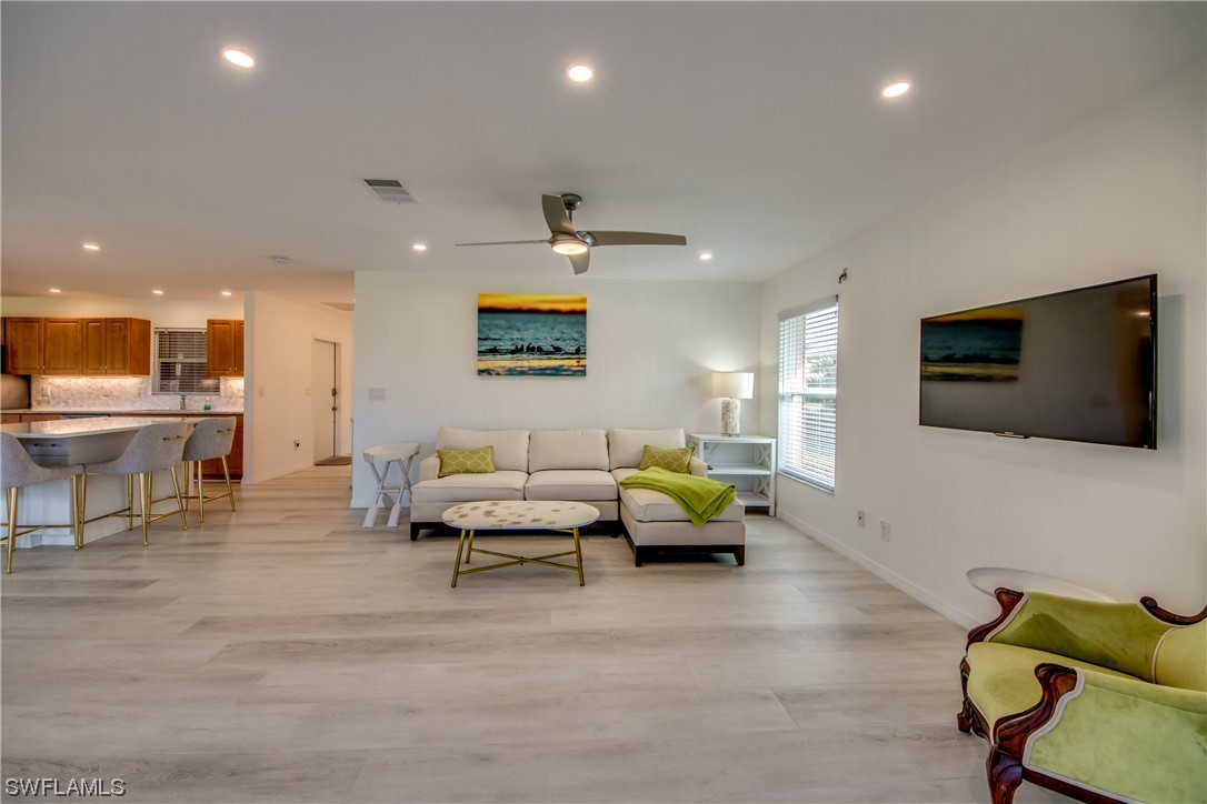 5585 Buring Court Fort Myers, FL 33919 - Photo 18 of 34 a living room with furniture and a flat screen tv