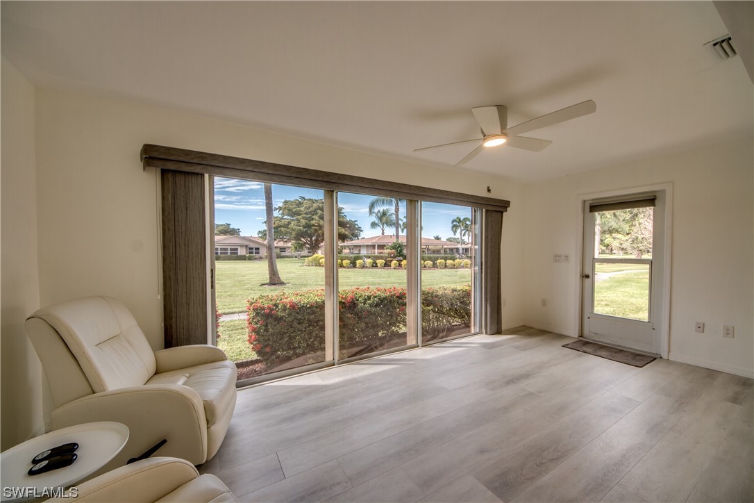 5585 Buring Court Fort Myers, FL 33919 - Photo 22 of 34 a living room with furniture and a floor to ceiling window