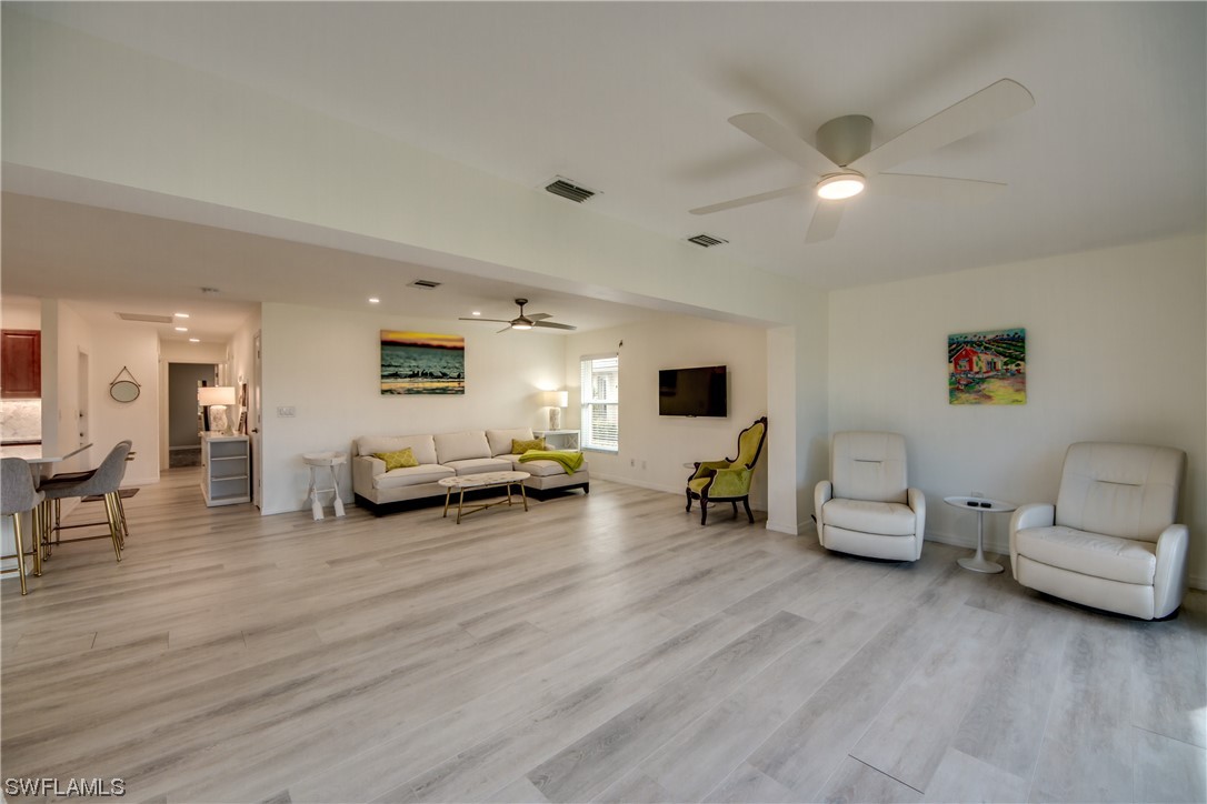 5585 Buring Court Fort Myers, FL 33919 - Photo 23 of 34 a living room with furniture and a wooden floor