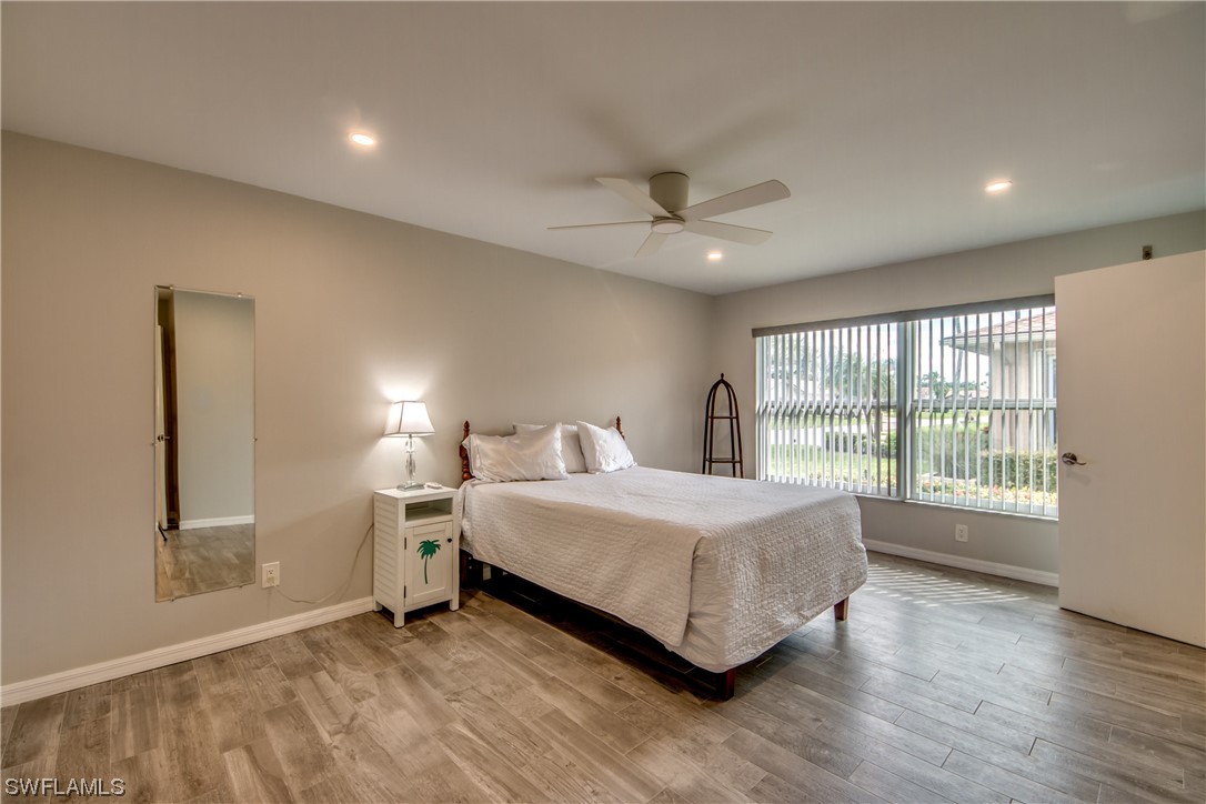5585 Buring Court Fort Myers, FL 33919 - Photo 24 of 34 a spacious bedroom with a bed and a large window