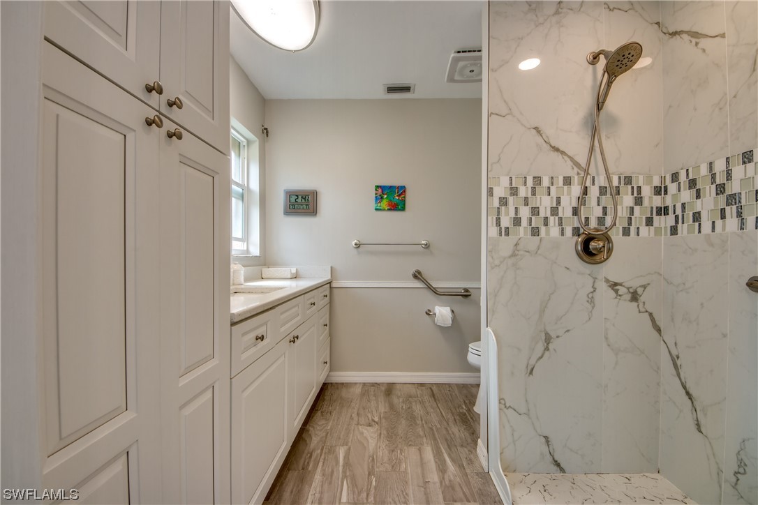 5585 Buring Court Fort Myers, FL 33919 - Photo 26 of 34 a bathroom with a double vanity sink and mirror