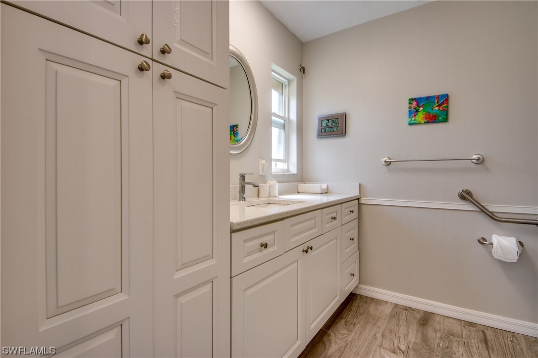 5585 Buring Court Fort Myers, FL 33919 - Photo 27 of 34 a bathroom with a double vanity sink and mirror