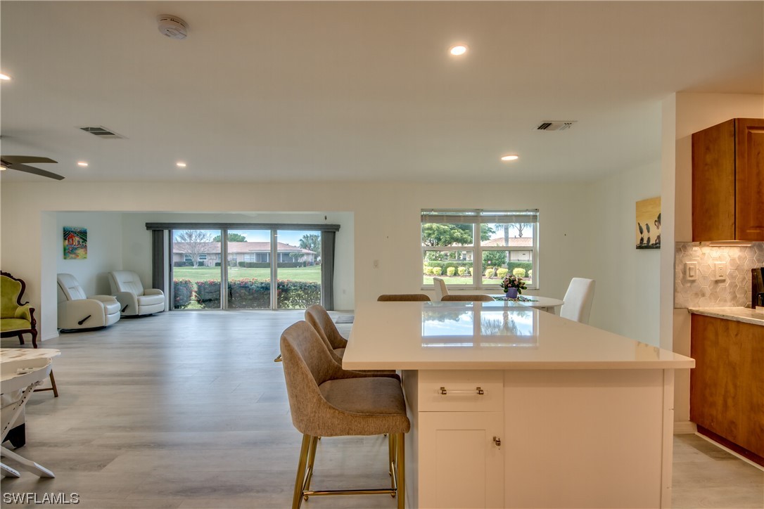 5585 Buring Court Fort Myers, FL 33919 - Photo 5 of 34 a view of a dining room with furniture wooden floor and a large window