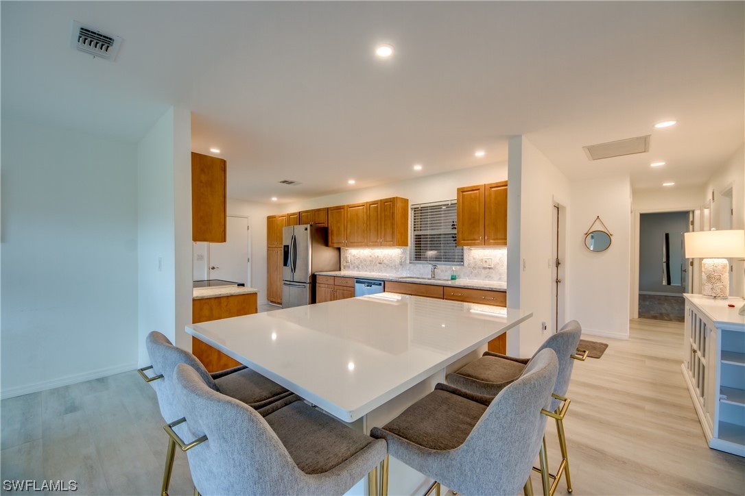 5585 Buring Court Fort Myers, FL 33919 - Photo 8 of 34 a large kitchen with a table and chairs