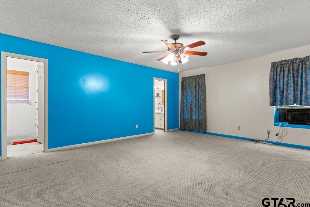6404 Black Gum Road Gilmer, TX 75644 - Photo 11 of 45 an empty room with windows and fan