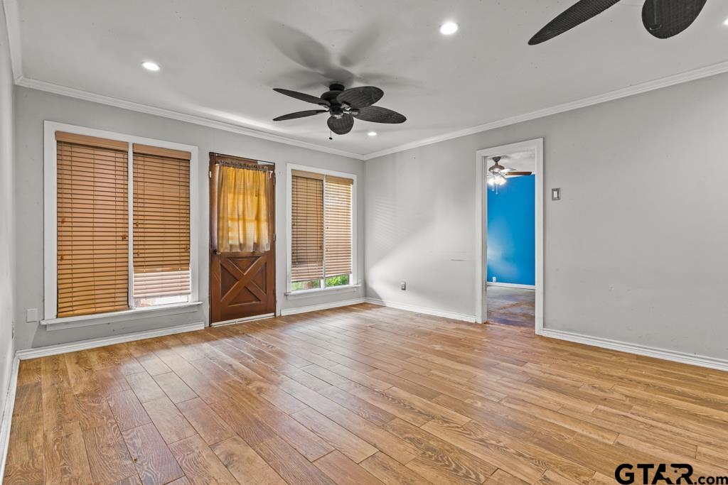 6404 Black Gum Road Gilmer, TX 75644 - Photo 14 of 45 a view of an empty room with a window and wooden floor