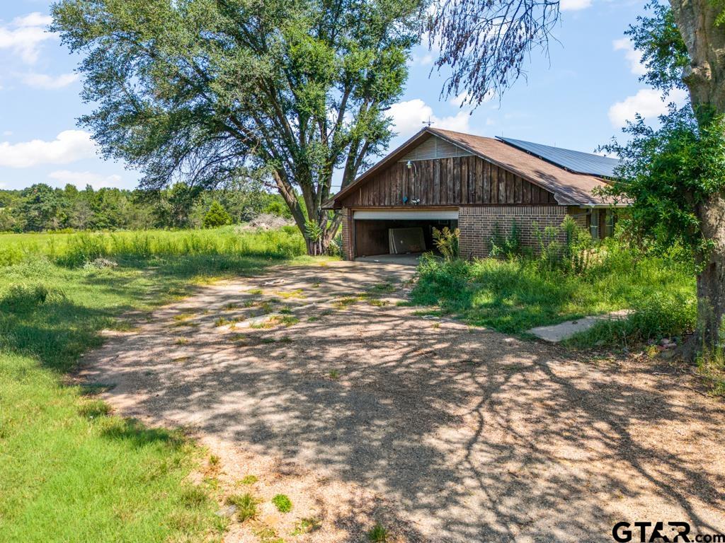 6404 Black Gum Road Gilmer, TX 75644 - Photo 2 of 45 a front view of a house with a yard and pathway