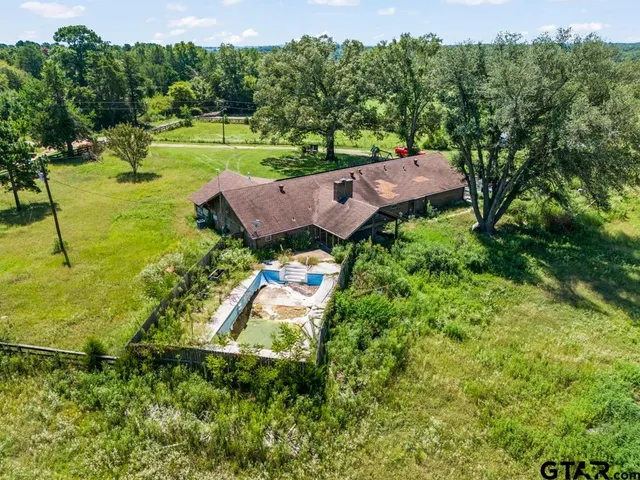 an aerial view of a house with garden space and street view