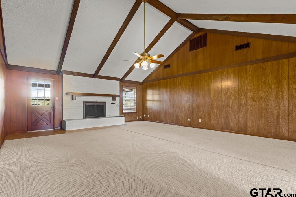 6404 Black Gum Road Gilmer, TX 75644 - Photo 5 of 45 a view of an empty room with a fireplace and a window