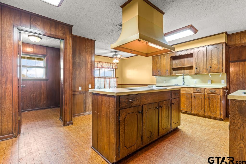 6404 Black Gum Road Gilmer, TX 75644 - Photo 9 of 45 a kitchen with stainless steel appliances granite countertop a sink and a stove next to a window