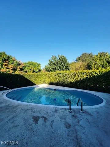 a view of a swimming pool with an outdoor space and seating area