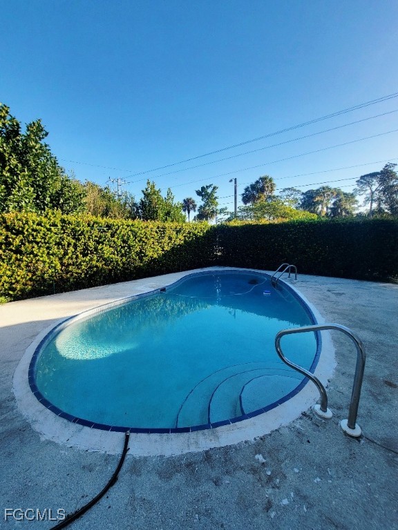 25 Maple Avenue North Lehigh Acres, FL 33936 - Photo 24 of 26 a view of a swimming pool with an outdoor space and seating area