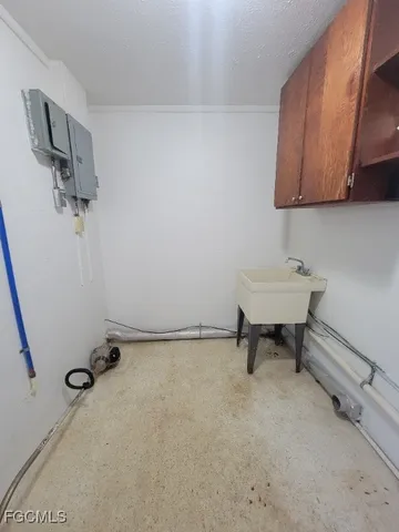 an empty room with windows and fan view