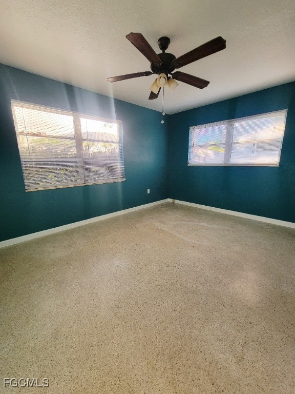 25 Maple Avenue North Lehigh Acres, FL 33936 - Photo 8 of 26 an empty room with windows and fan view