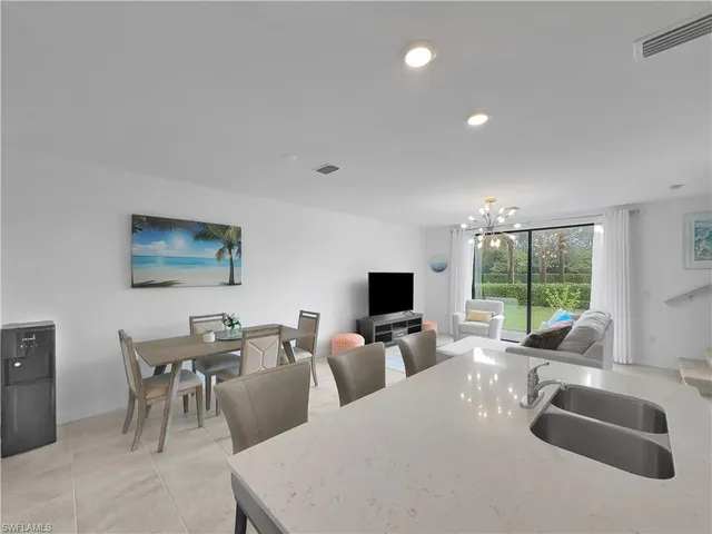 a living room with furniture a large window and a flat screen tv