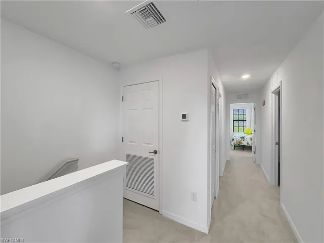 a view of a hallway with wooden shelves