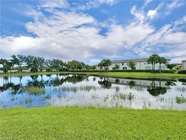 a view of a lake with houses in the background