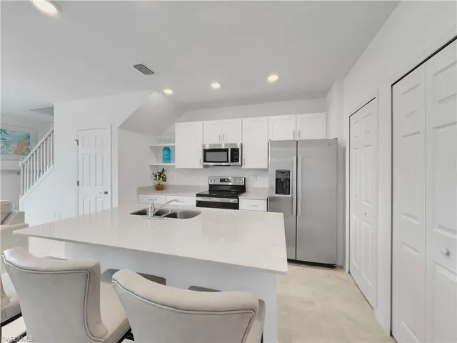 a kitchen with a sink a stove and refrigerator