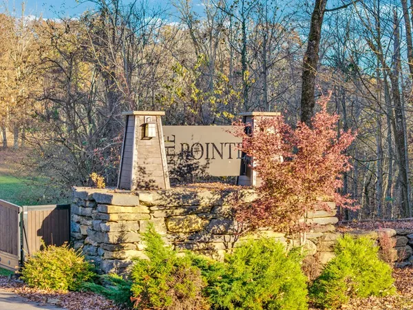 a sign board with buildings in the background