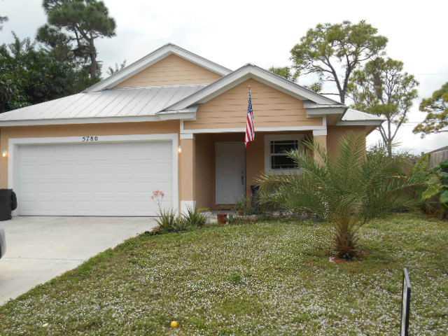 5780 Southeast Colee Avenue Stuart, FL 34997 - Photo 1 of 25 a front view of house with yard