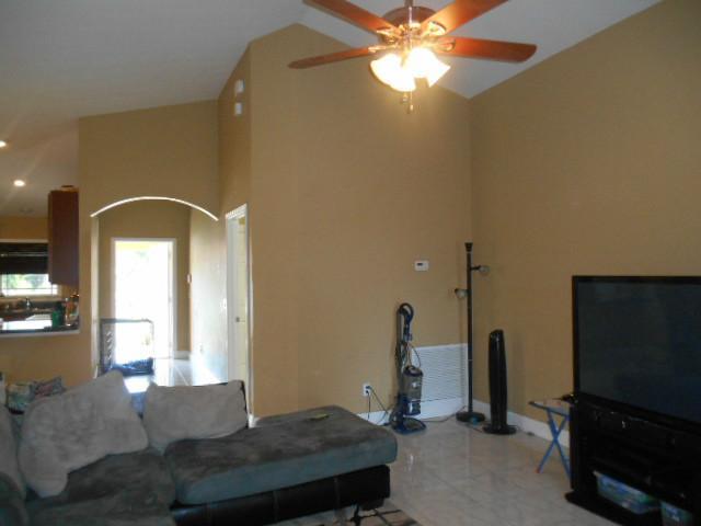 5780 Southeast Colee Avenue Stuart, FL 34997 - Photo 13 of 25 a living room with furniture and a flat screen tv