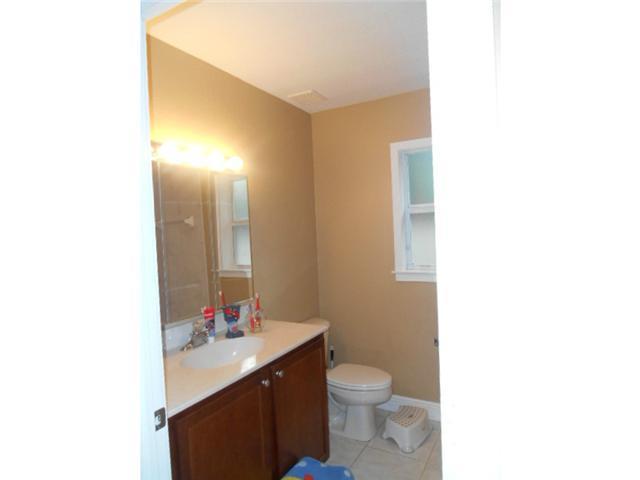 5780 Southeast Colee Avenue Stuart, FL 34997 - Photo 18 of 25 a bathroom with a sink vanity mirror and toilet