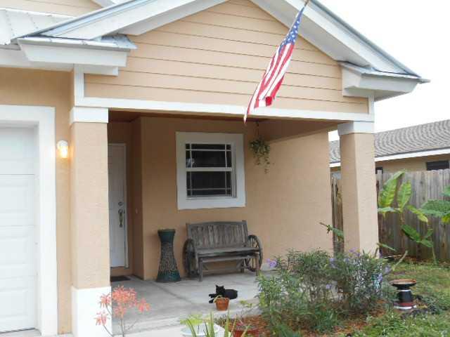 5780 Southeast Colee Avenue Stuart, FL 34997 - Photo 2 of 25 a front view of a house with a garage