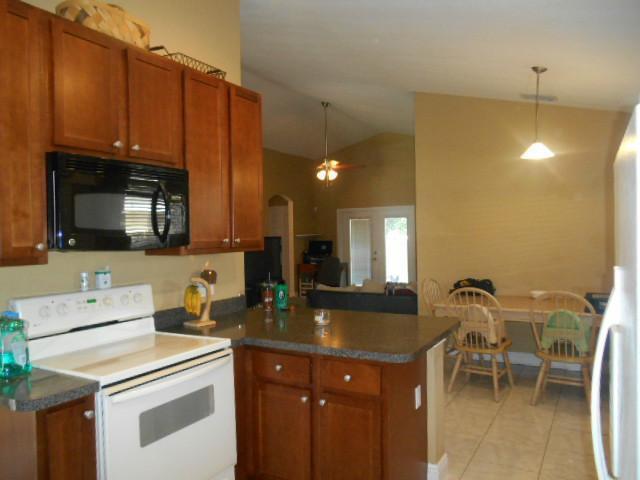 5780 Southeast Colee Avenue Stuart, FL 34997 - Photo 8 of 25 a kitchen with a sink cabinets and microwave