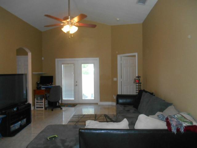 5780 Southeast Colee Avenue Stuart, FL 34997 - Photo 10 of 25 a living room with furniture and a flat screen tv