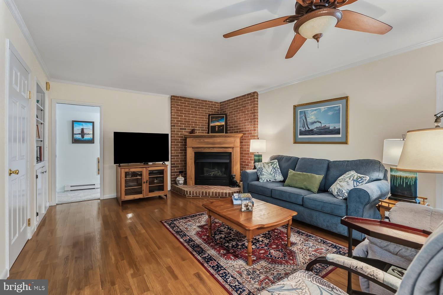814 Wrights Neck Road Centreville, MD 21617 - Photo 32 of 53 a living room with furniture a flat screen tv and a fireplace