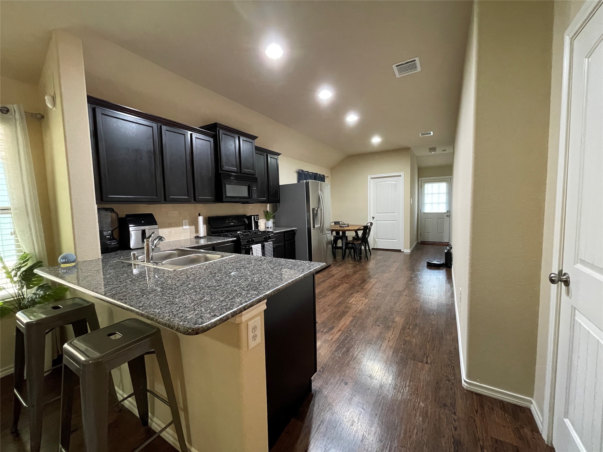 3650 Sumner Lodge Drive Katy, TX 77449 - Photo 16 of 41 a kitchen with a table chairs a sink dishwasher stove and cabinets with wooden floor