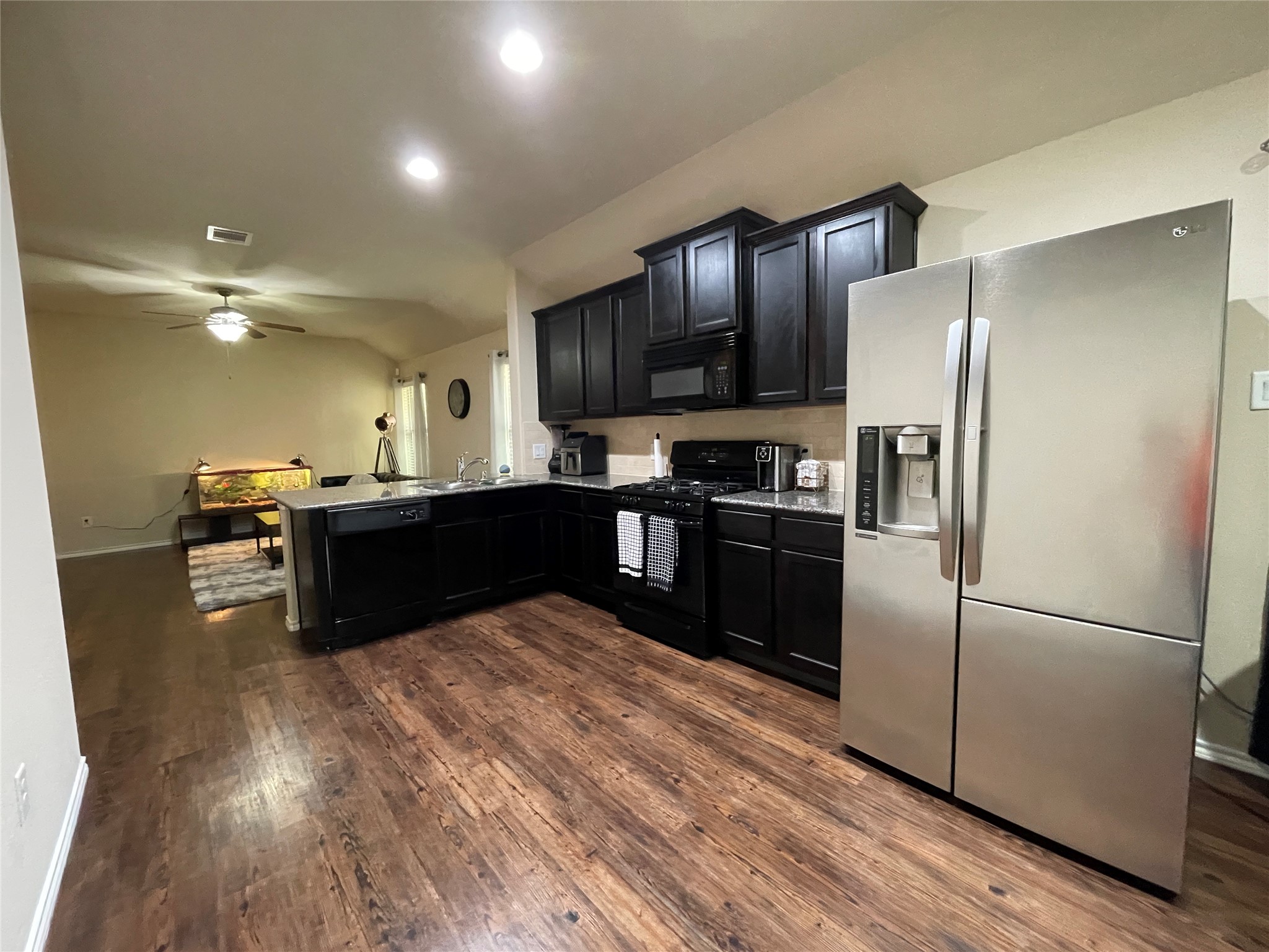 3650 Sumner Lodge Drive Katy, TX 77449 - Photo 17 of 41 a kitchen with stainless steel appliances granite countertop a refrigerator a sink a stove a microwave and wooden floors