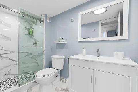 a bathroom with a toilet sink and shower