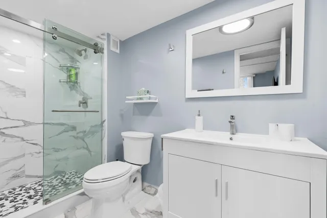a bathroom with a toilet sink and shower