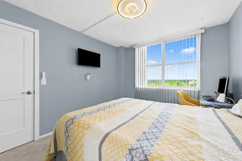 a bedroom with a bed and a flat screen tv