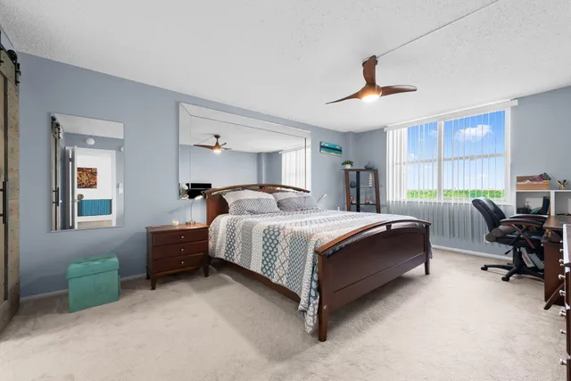 a bedroom with bed couch and window